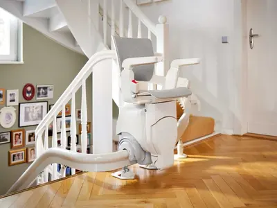Bright interior curved stairlift on a wooden staircase in Bland.